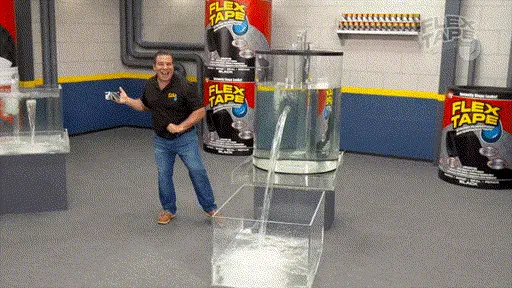 Phil Swift slaps a piece of black Flex Tape onto a glass water tank, instantly stopping the water from leaking out.